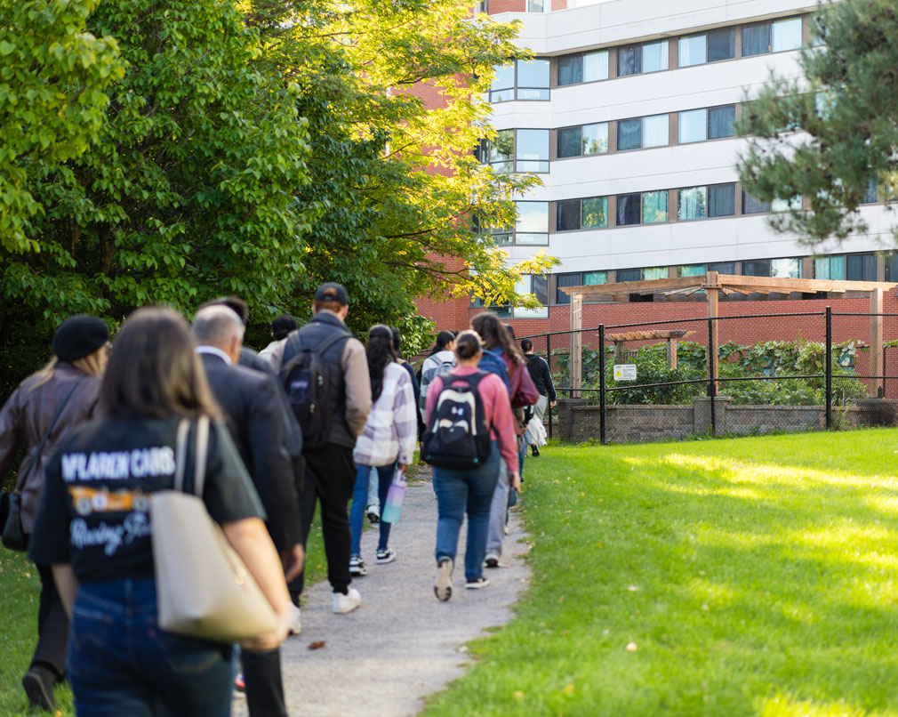 Students walking along path towards community garden