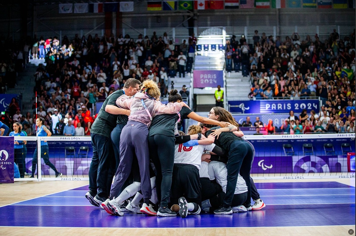 Team huddling at Paris Paralympics