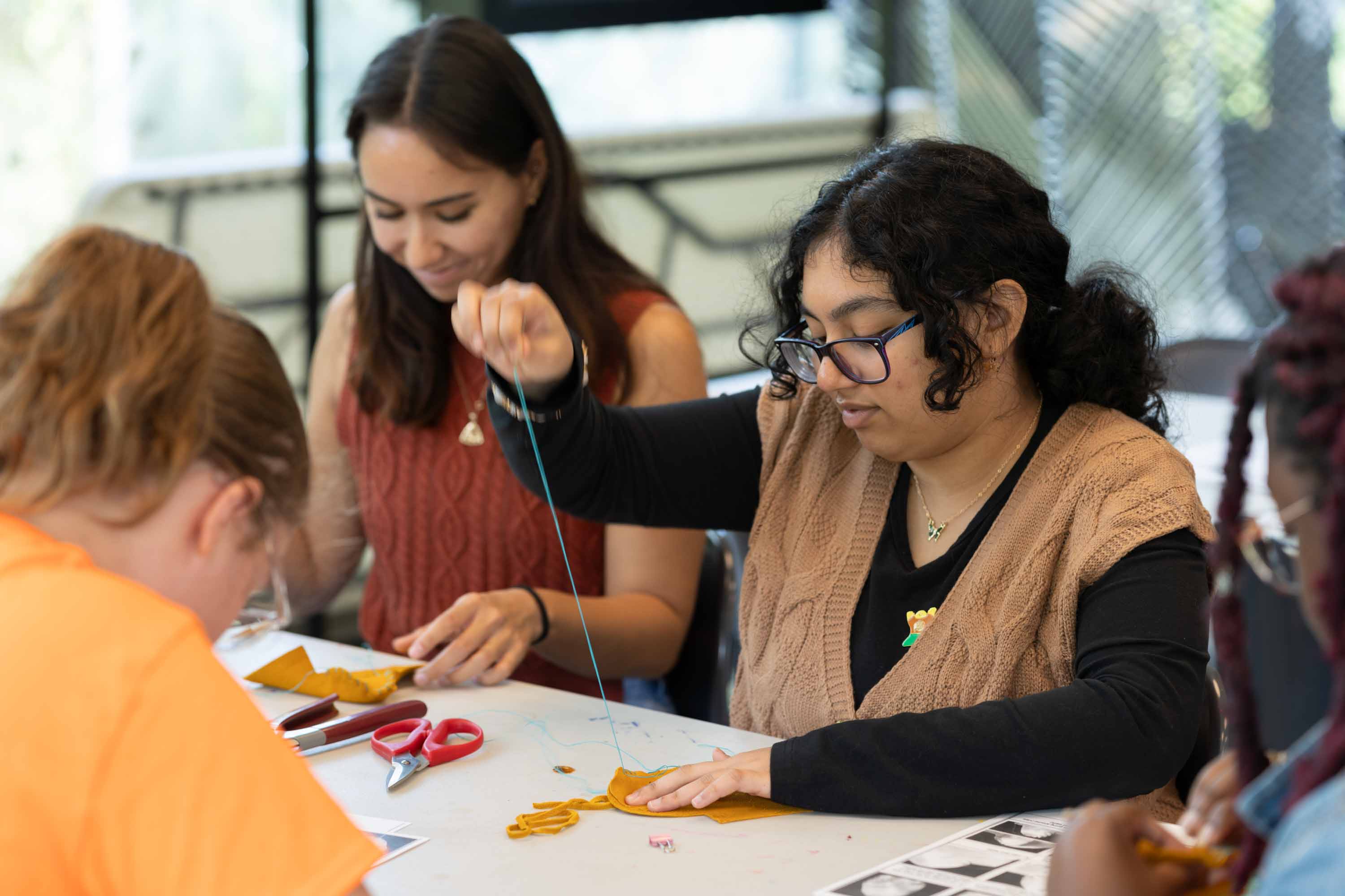 Students making traditional Indigenous moccasins