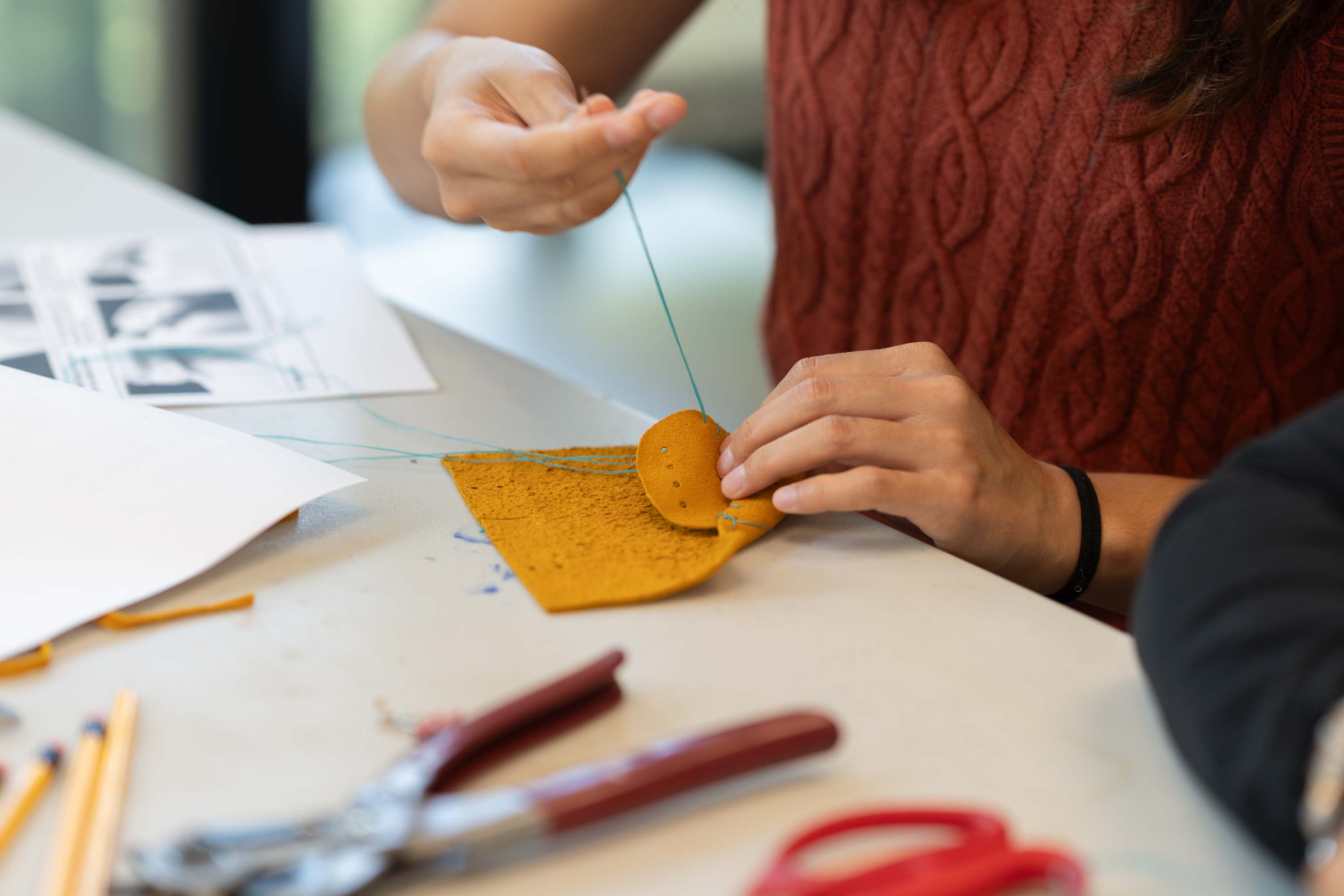 Student making traditional Indigenous moccasins